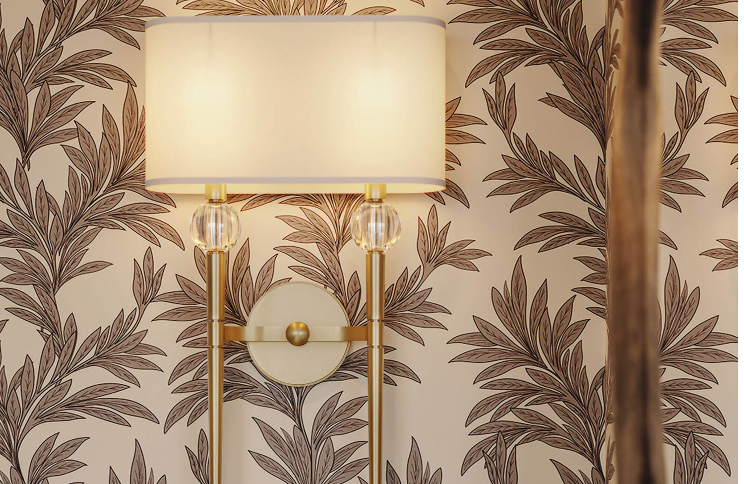 Botanical wallpaper with brass wall sconce and fabric shade, featuring warm neutral tones and leafy patterns that bring nature indoors.