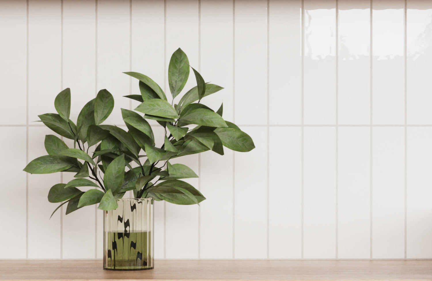 Minimalist white subway tile wall providing a clean backdrop to a vibrant green potted plant, enhancing the natural decor.