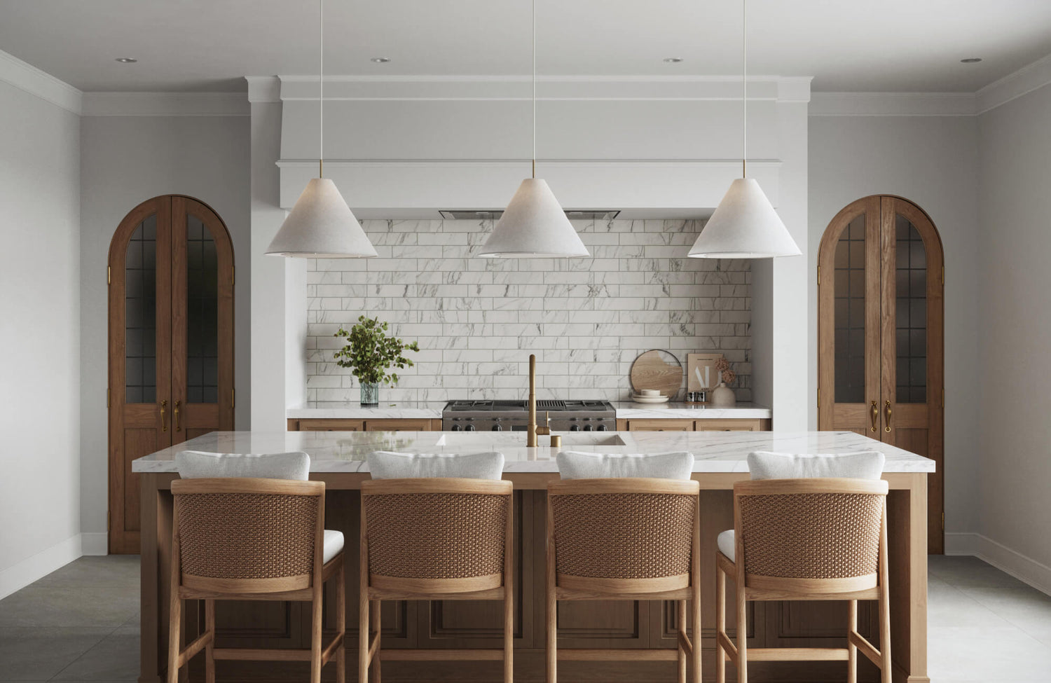 Modern kitchen with marble look subway tile backsplash, cone pendant lights, and rattan-back bar stools.