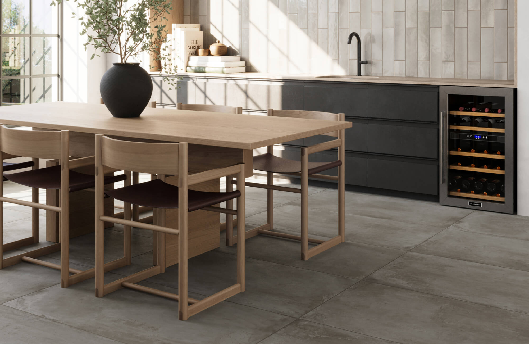 Neutral-toned large format floor tiles with a concrete finish enhance this modern, minimalist kitchen space.