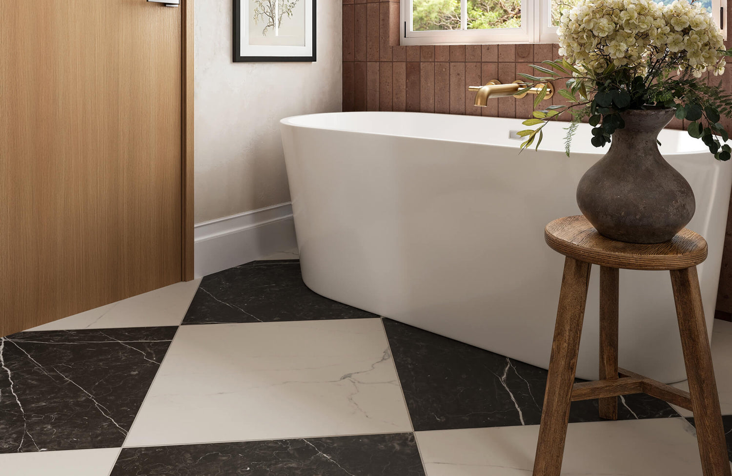 Elegant bathroom with classic black and white checkerboard tile, freestanding tub, and rustic wooden stool with floral vase.
