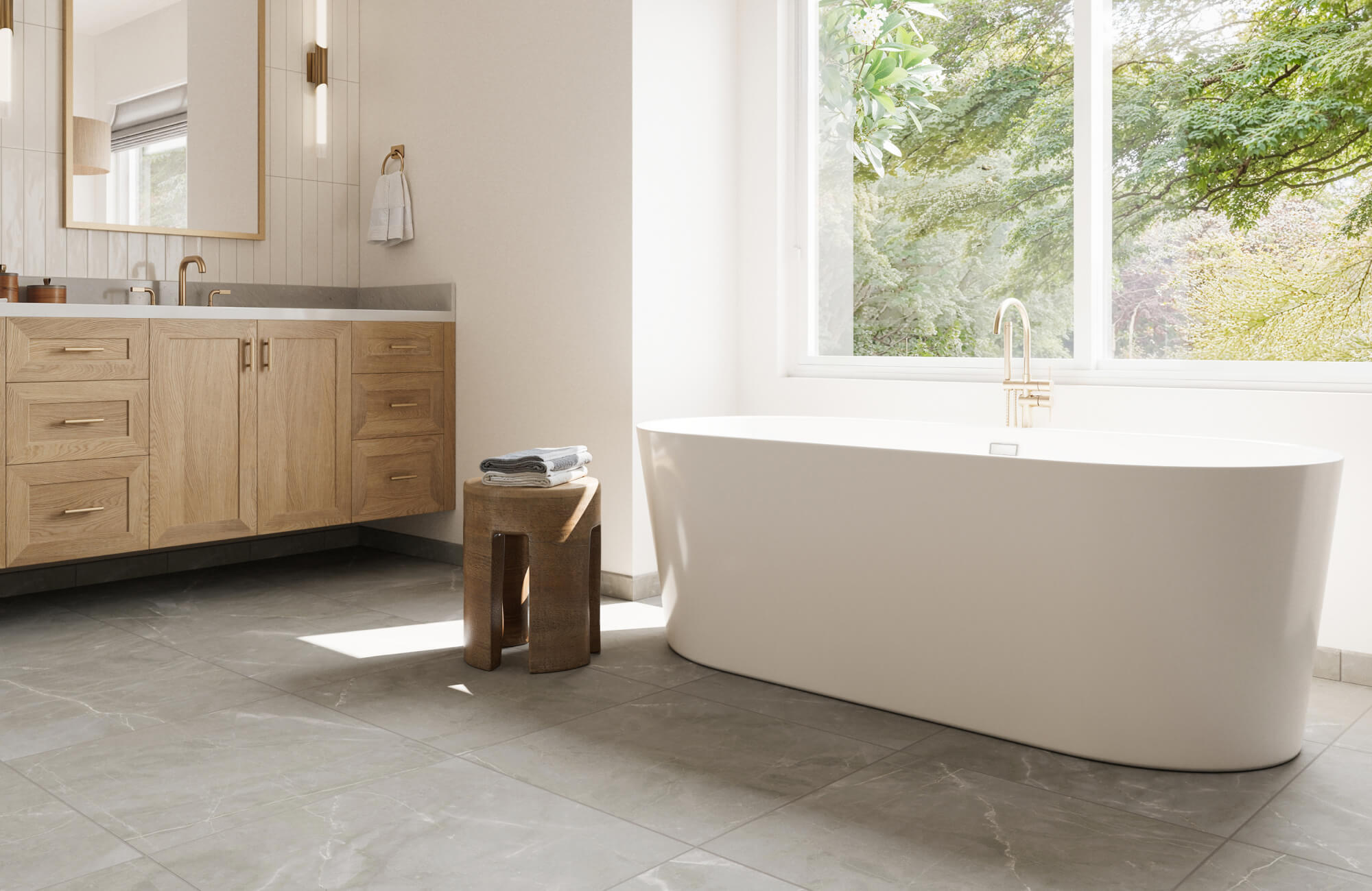 Spacious bathroom with sleek grey floor tiles, a modern freestanding bathtub, and light wood cabinetry, creating a serene and natural ambiance.