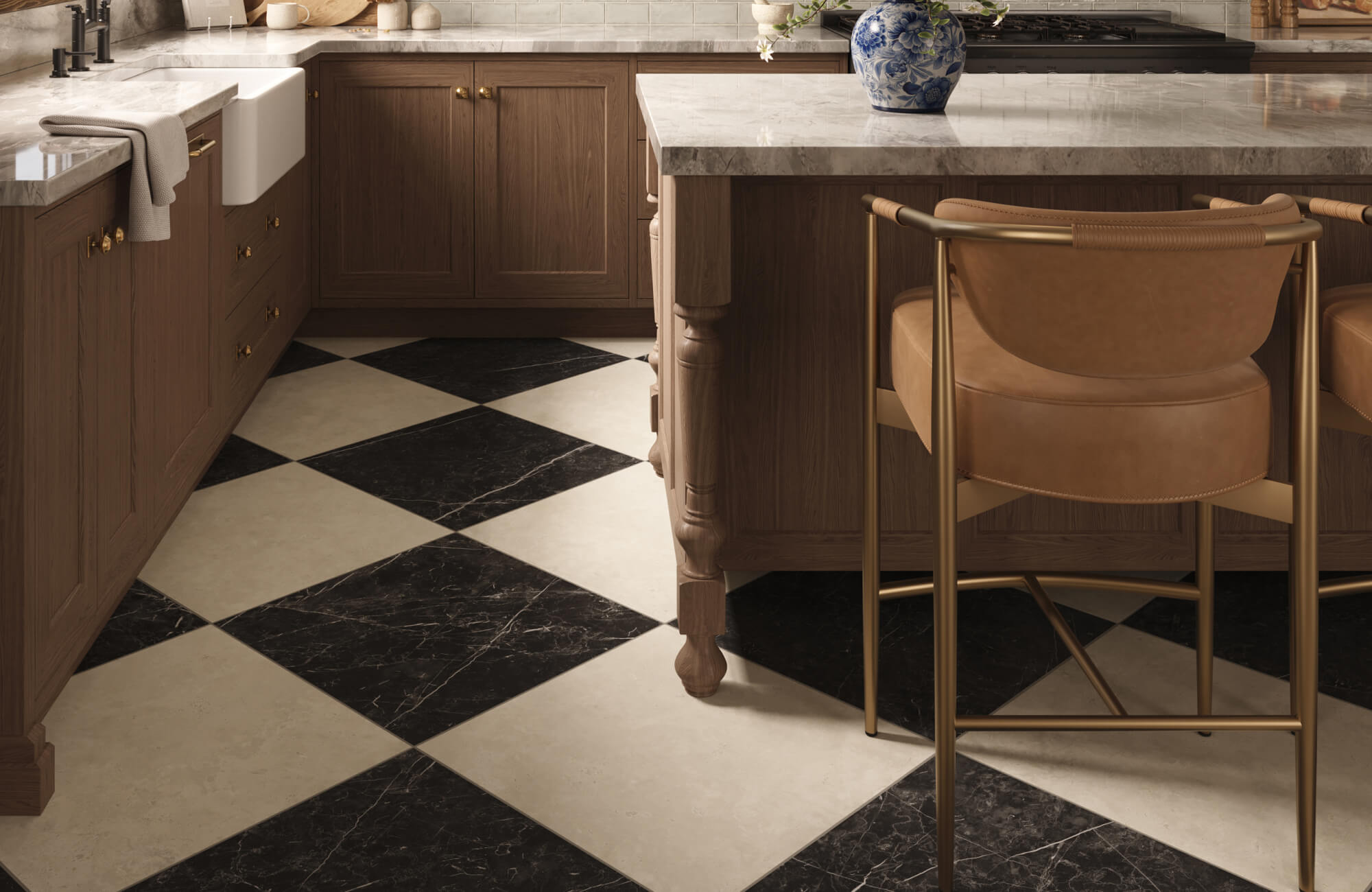 Marble look checkered tiles in a black and white pattern installed on a kitchen floor with warm wood cabinetry and a marble countertop island.