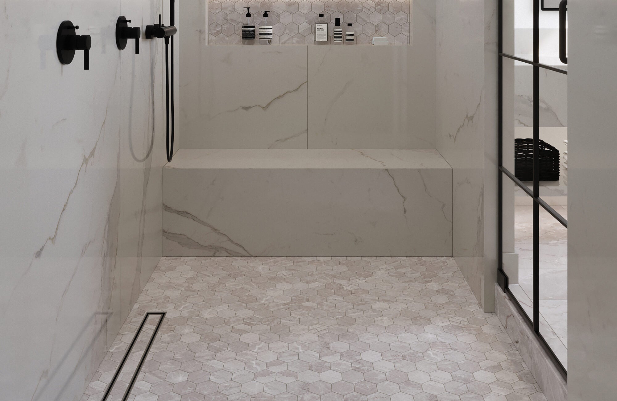 Matte hexagonal mosaic tiles in soft gray tones create a textured and slip-resistant shower floor, complemented by large marble-look wall tiles for a sleek, cohesive design.