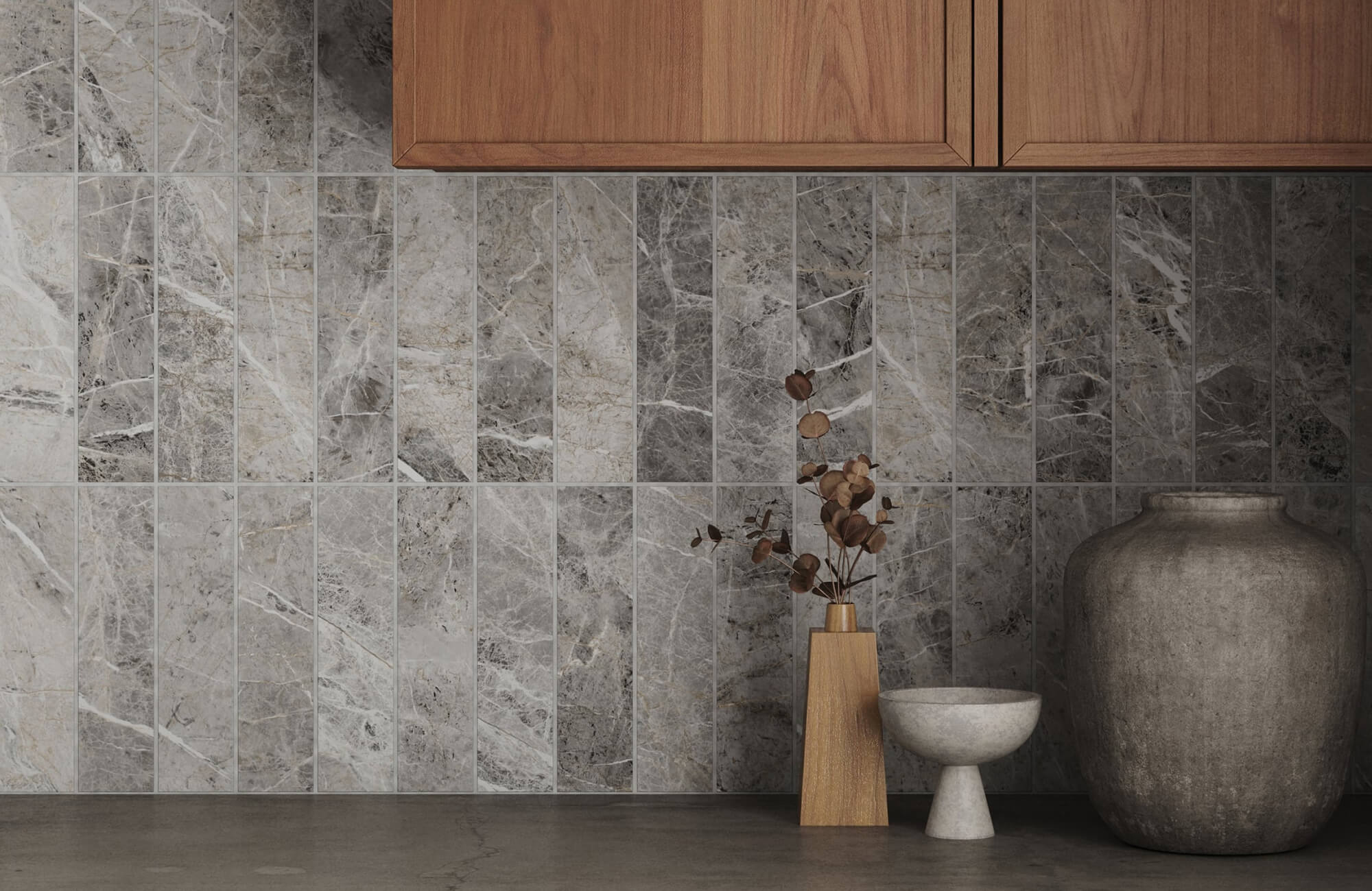 Gray marble-look subway tile backsplash in a vertical stack, set beneath warm wood cabinetry.