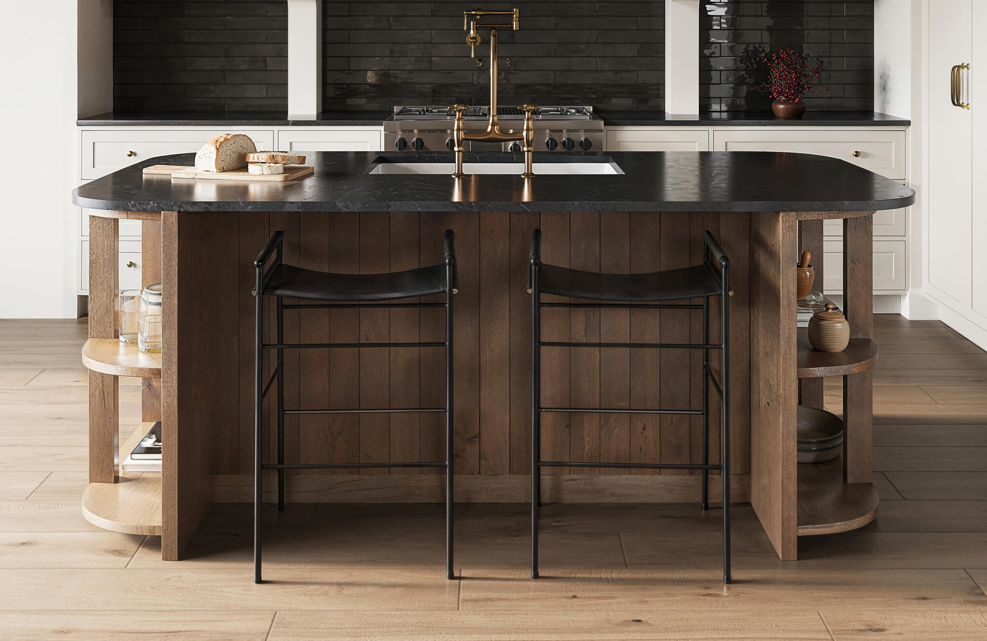 Modern kitchen with dark wood island, black countertops, and matte black subway tile backsplash on wood look tile flooring.