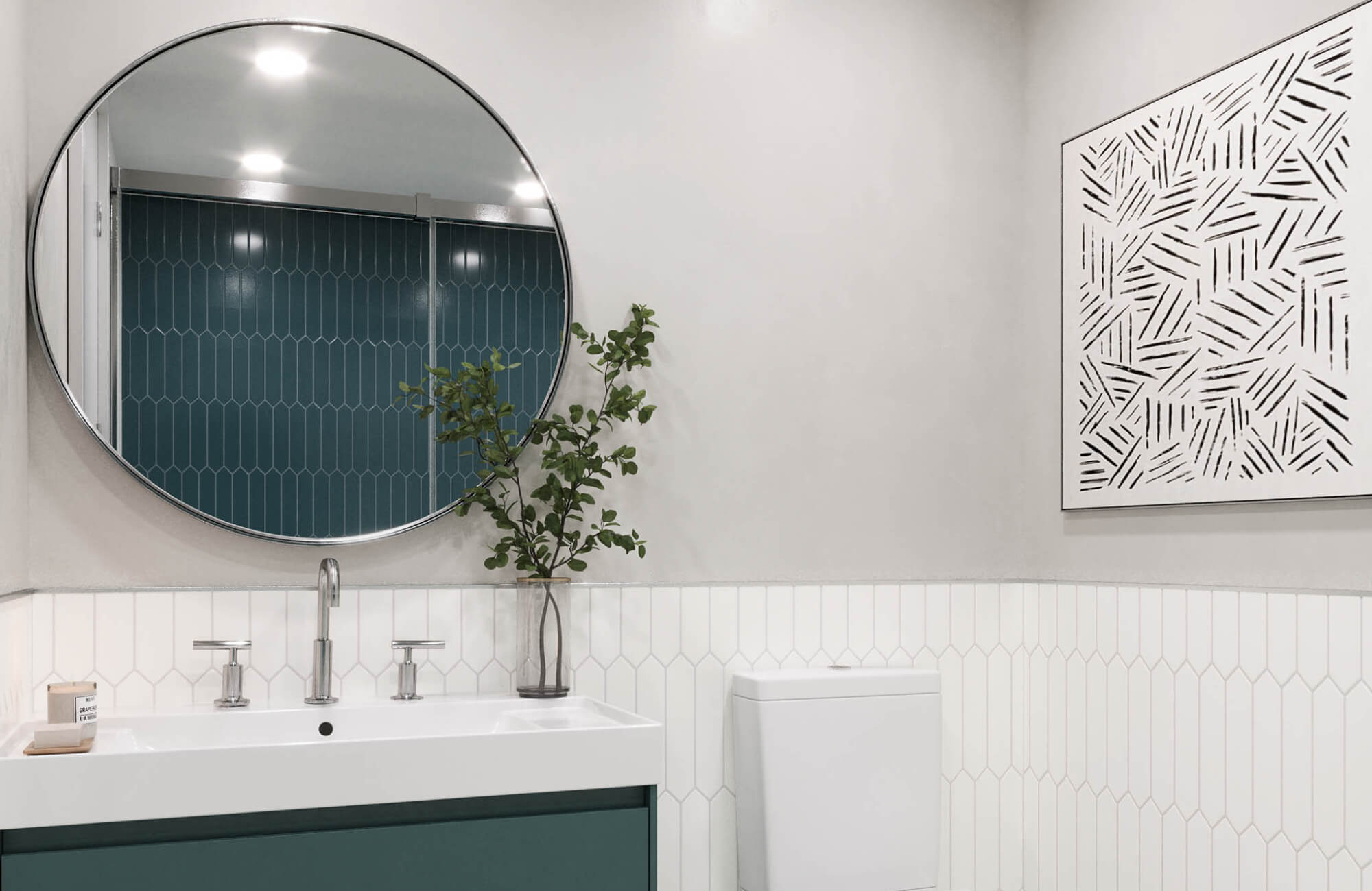 Large round mirror above a modern vanity reflecting teal shower tile in a clean, minimalist bathroom.