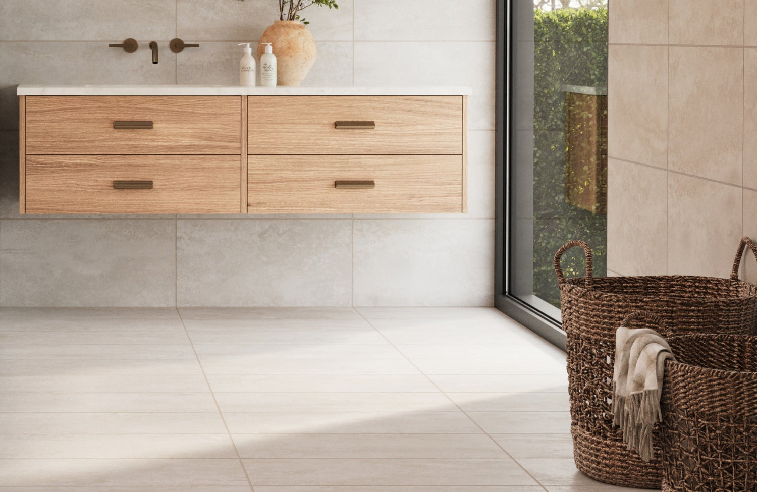 Minimalist bathroom with matte ceramic tiles on the floor and walls, a floating wood vanity, and woven baskets for added texture.