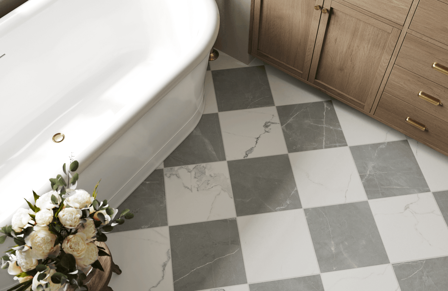 Bathroom with gray and white checkered marble look tiles, a freestanding tub, and warm wood cabinetry with brass hardware for a cozy, elegant vibe.
