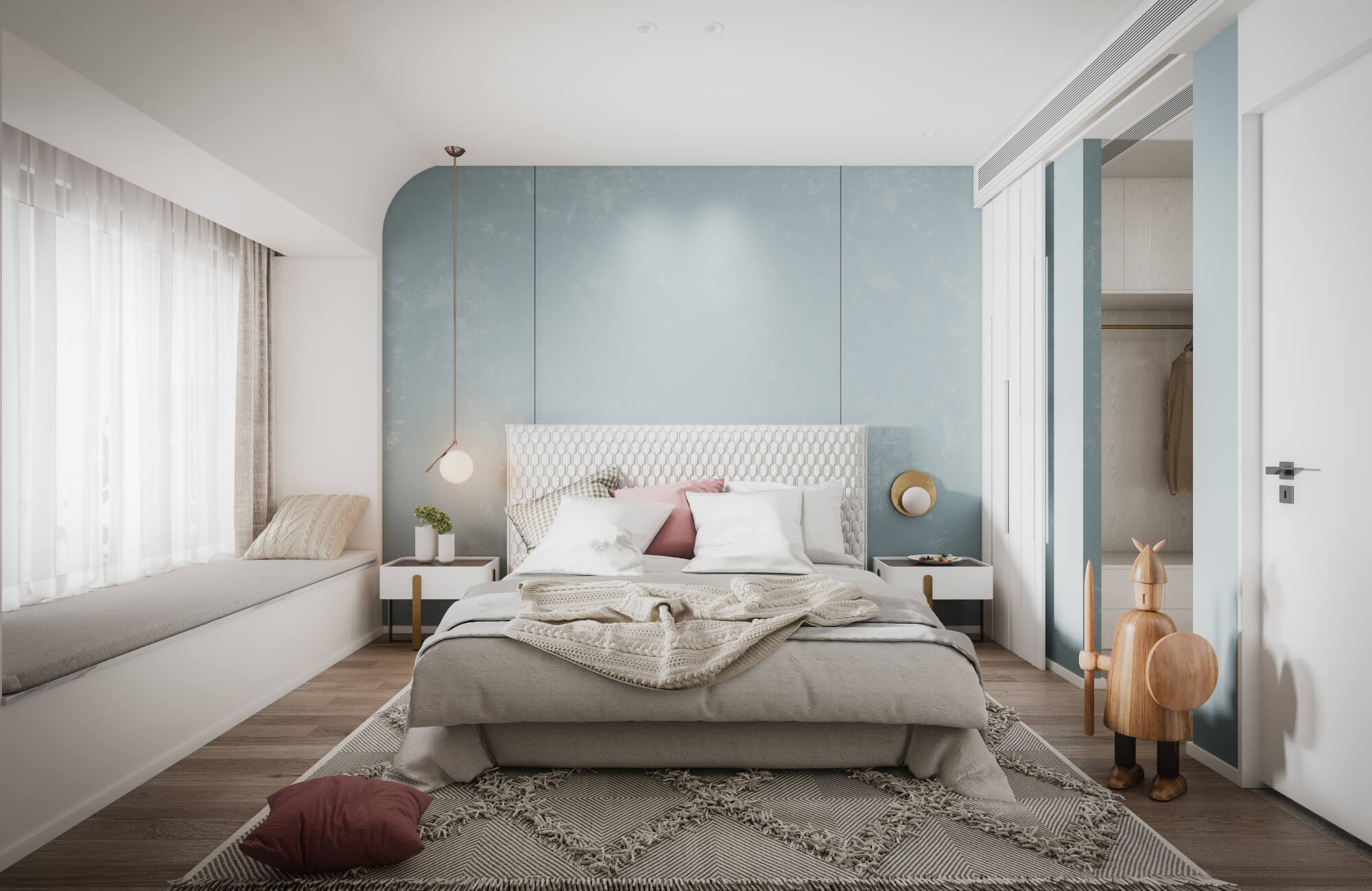 Modern bedroom with a soft blue accent wall, neutral bedding, geometric wool rug, and natural light streaming through sheer curtains.