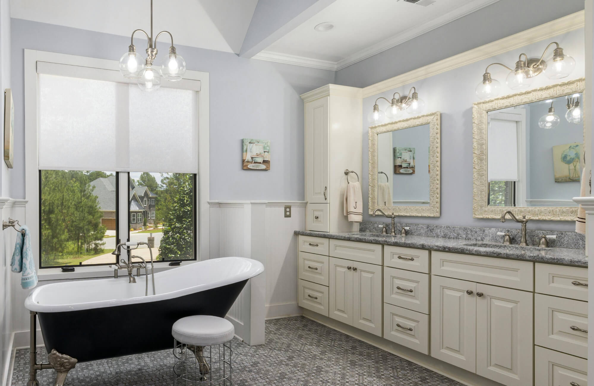 Modern bathroom featuring a sleek vanity and mirror illuminated by a warm, wall-mounted bathroom light that enhances the space with soft glow, functional clarity, and refined ambiance.