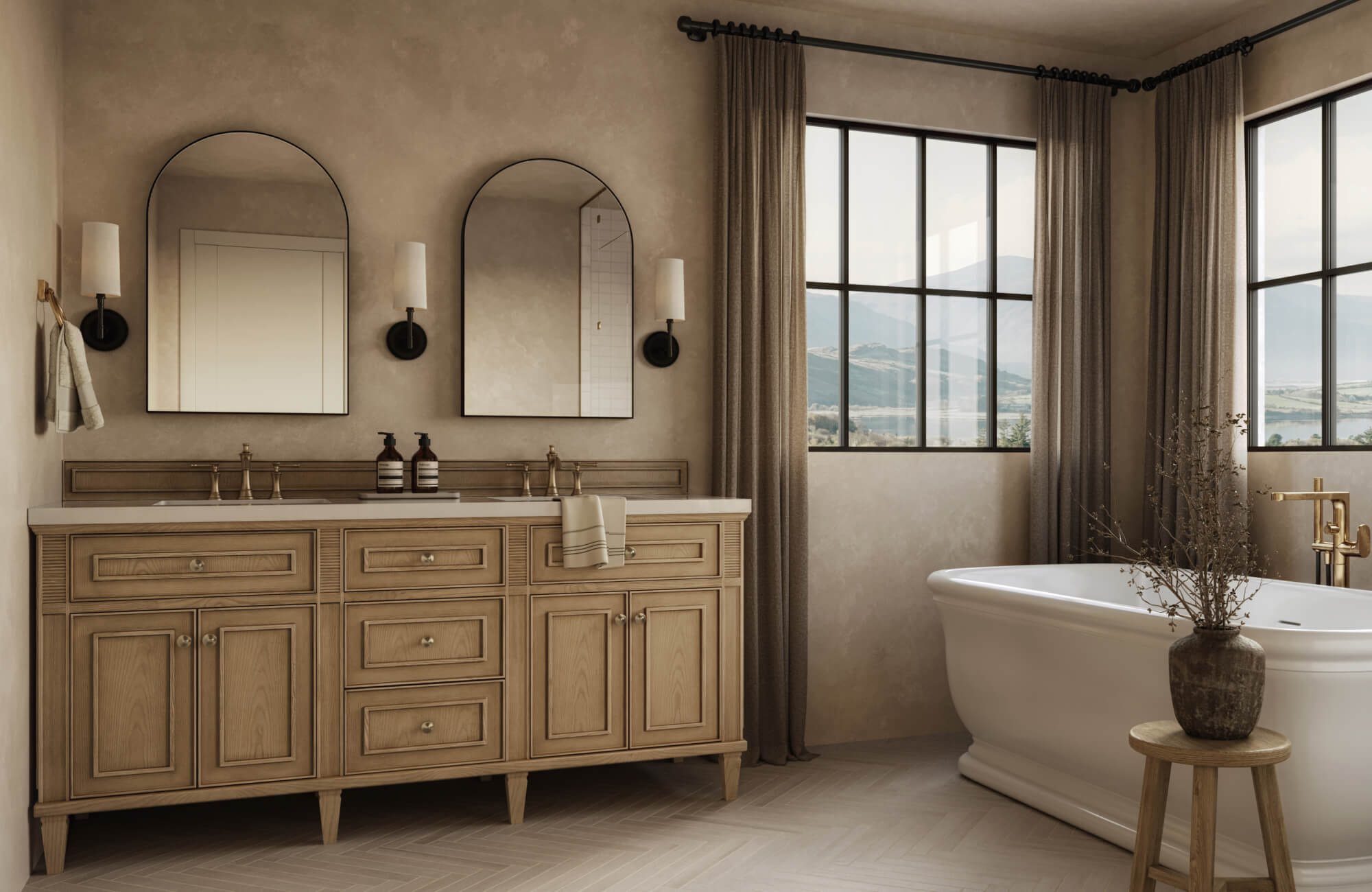 Elegant bathroom with herringbone-patterned porcelain floor tile, double vanity, and freestanding tub with mountain views.