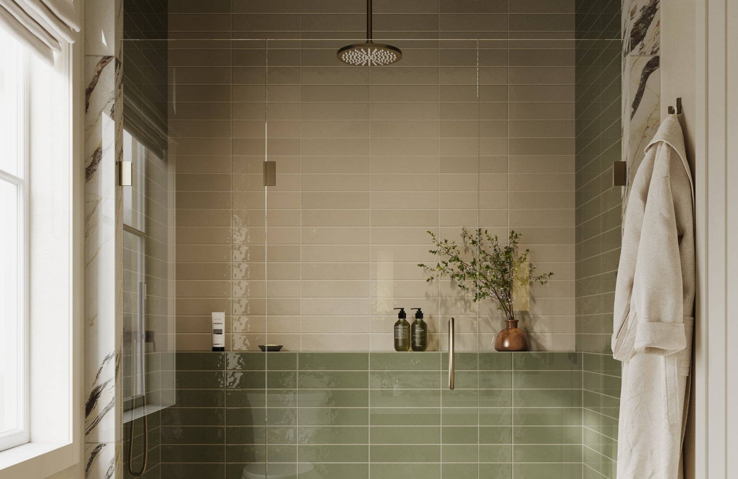 Neutral beige and green subway tiles in a modern shower with a glass door, a rainfall showerhead, and a built-in ledge.