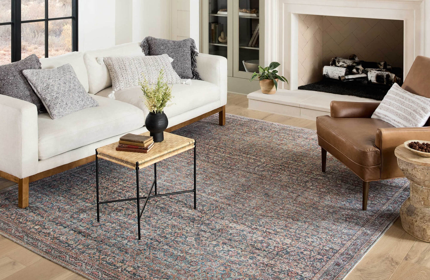 Sofa with layered pillows, larger cushions at the back, and smaller decorative pillows placed neatly in front.