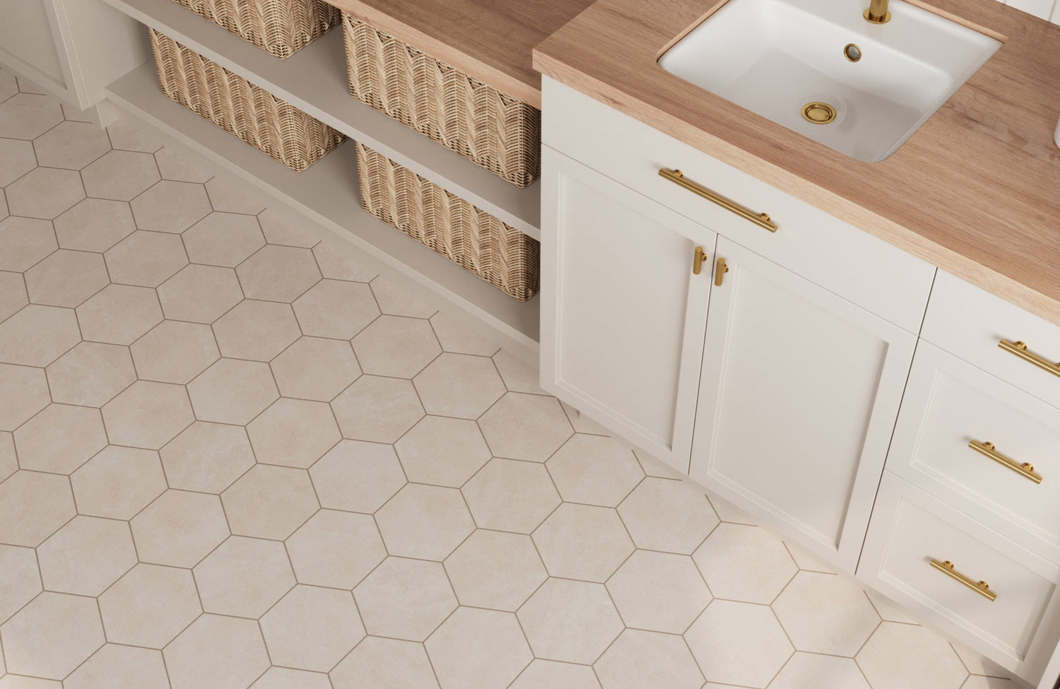 Light beige hexagon floor tiles paired with white cabinetry, gold hardware, and woven storage baskets for a clean, airy laundry room design.