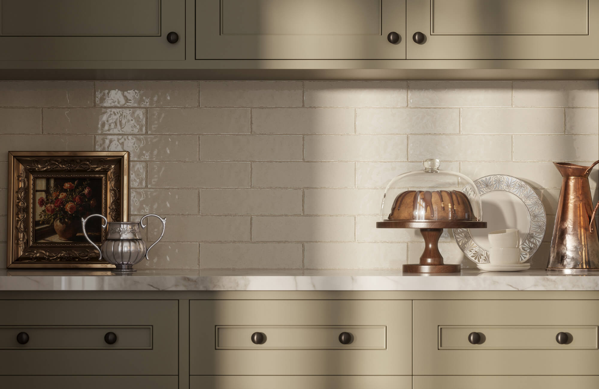 Cream subway tile backsplash with neutral cabinets, marble counter, and decorative kitchen accessories styled against a softly lit wall.