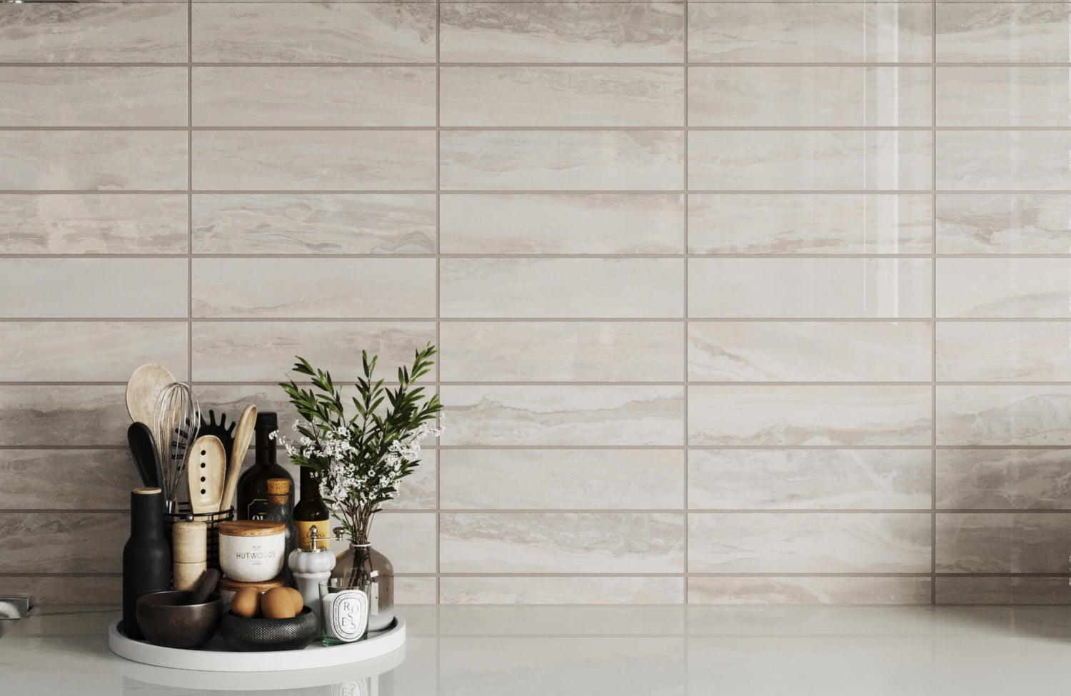 Stylish kitchen backsplash featuring beige subway tiles with a sleek marble pattern and a minimalist utensil holder.