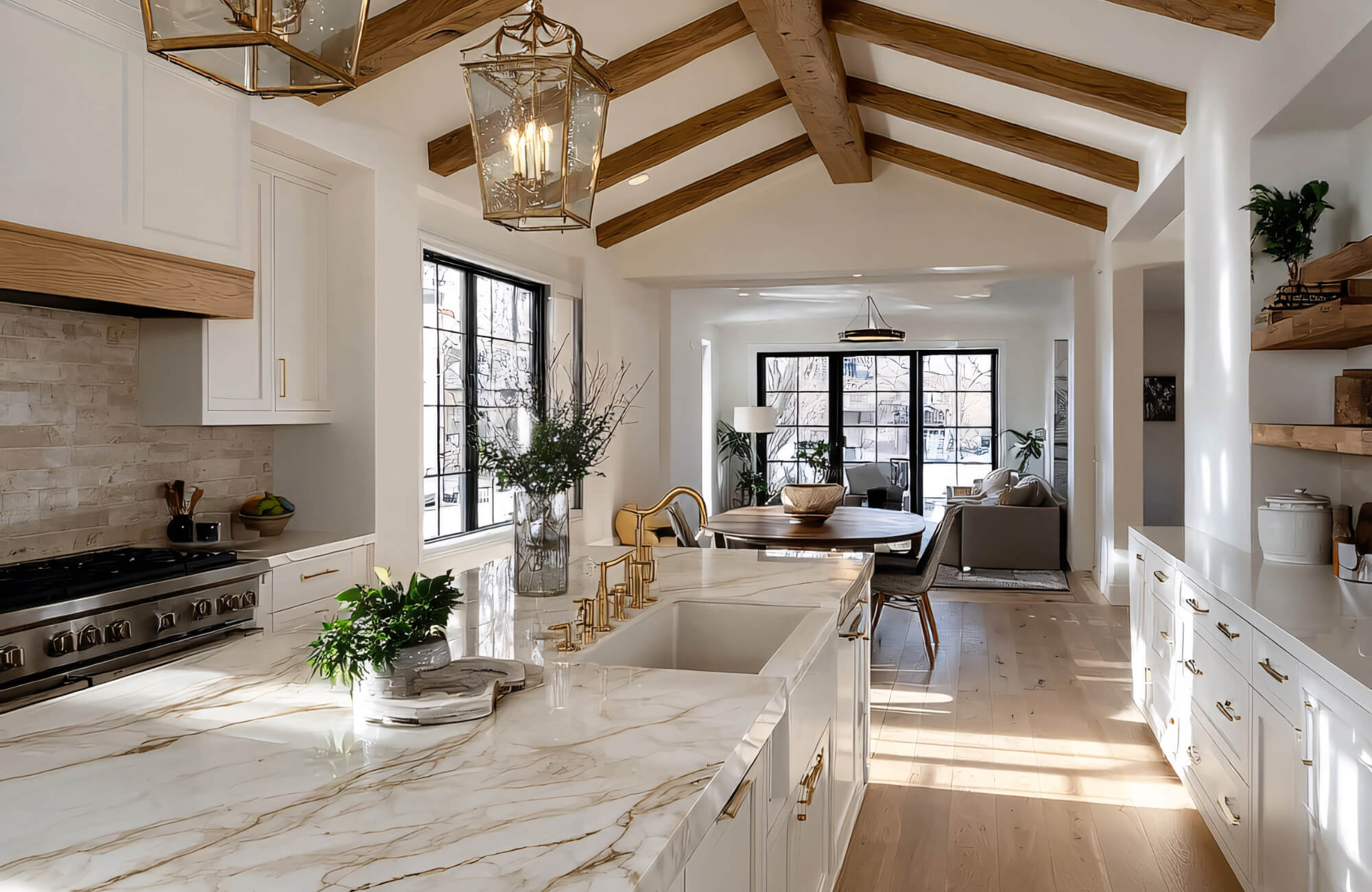 Bright modern kitchen with marble island, brass pendants, and recessed lighting designed to deliver shadow-free task illumination.