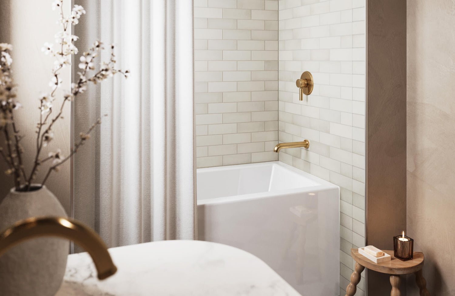 Small classy bathroom with white subway tile shower walls, brass fixtures, and soft neutral decor creating a clean and elegant space.