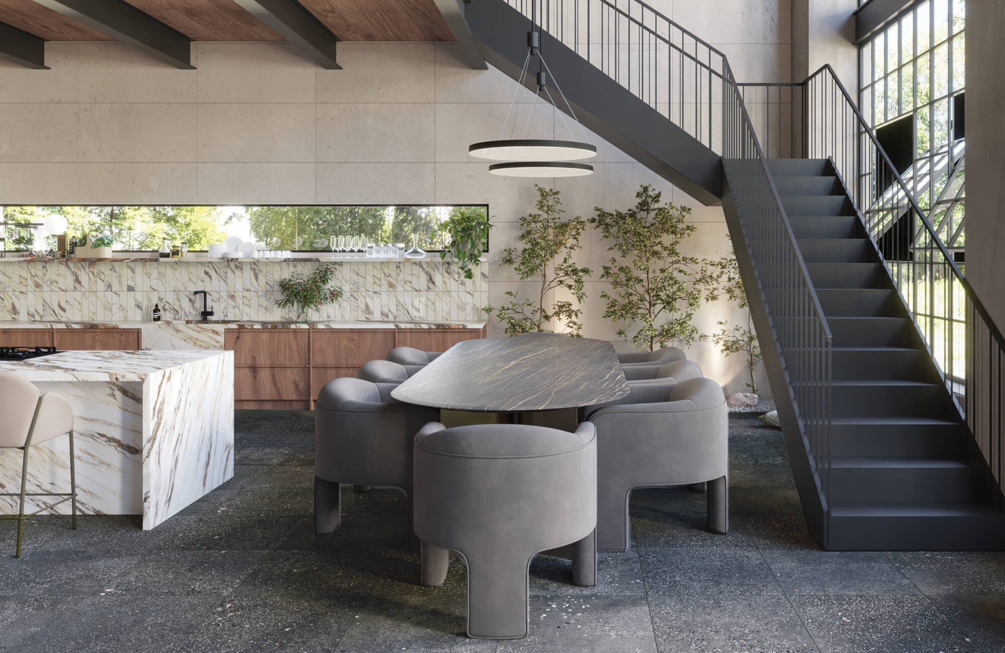 Sleek open-plan kitchen featuring cement look stone floor tiles, veined marble surfaces, and plush grey dining chairs in a modern setting.