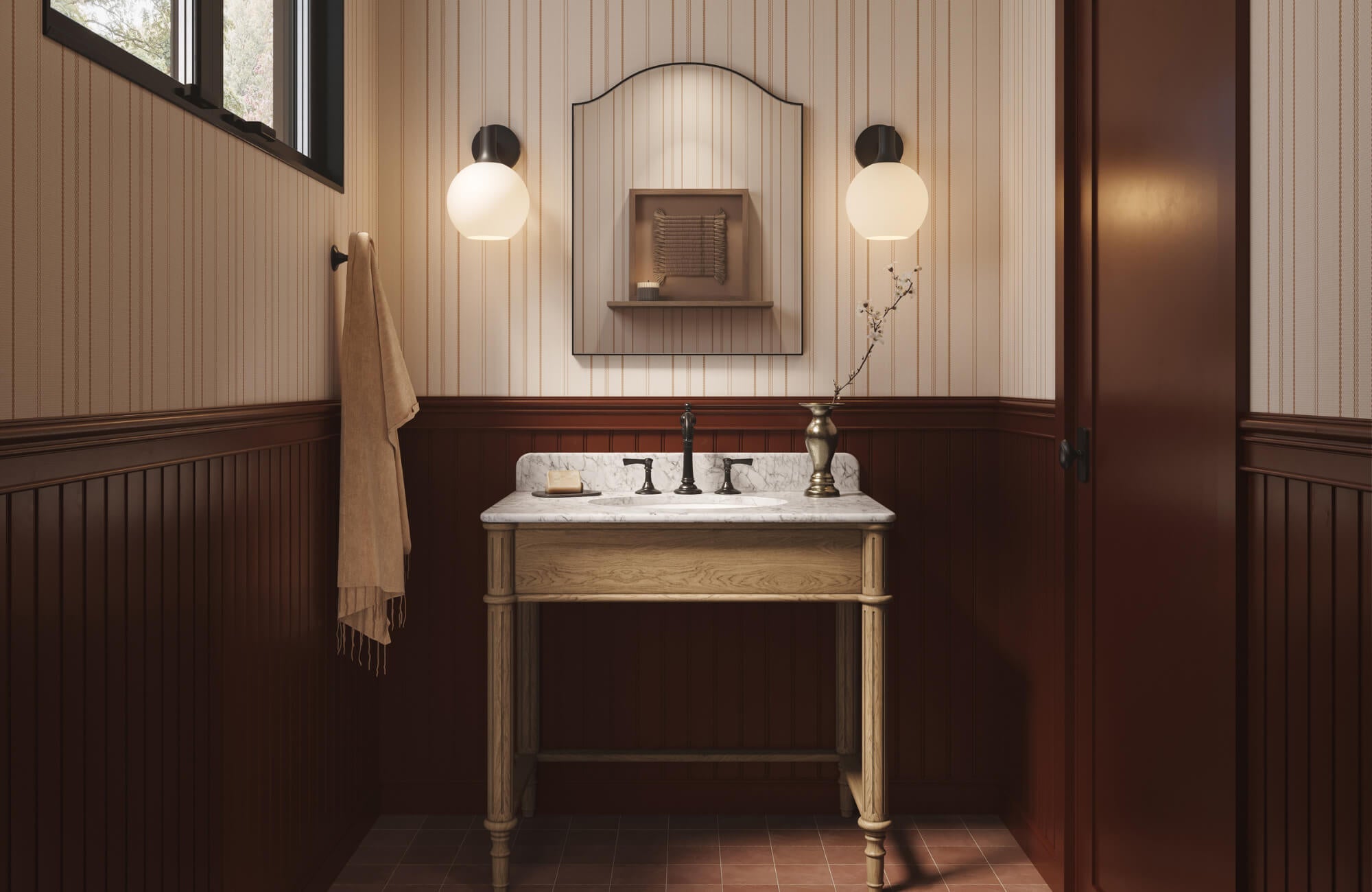 Cozy bathroom with striped white wallpaper, dark wood wainscoting, marble vanity, and warm globe sconces beside the mirror above.