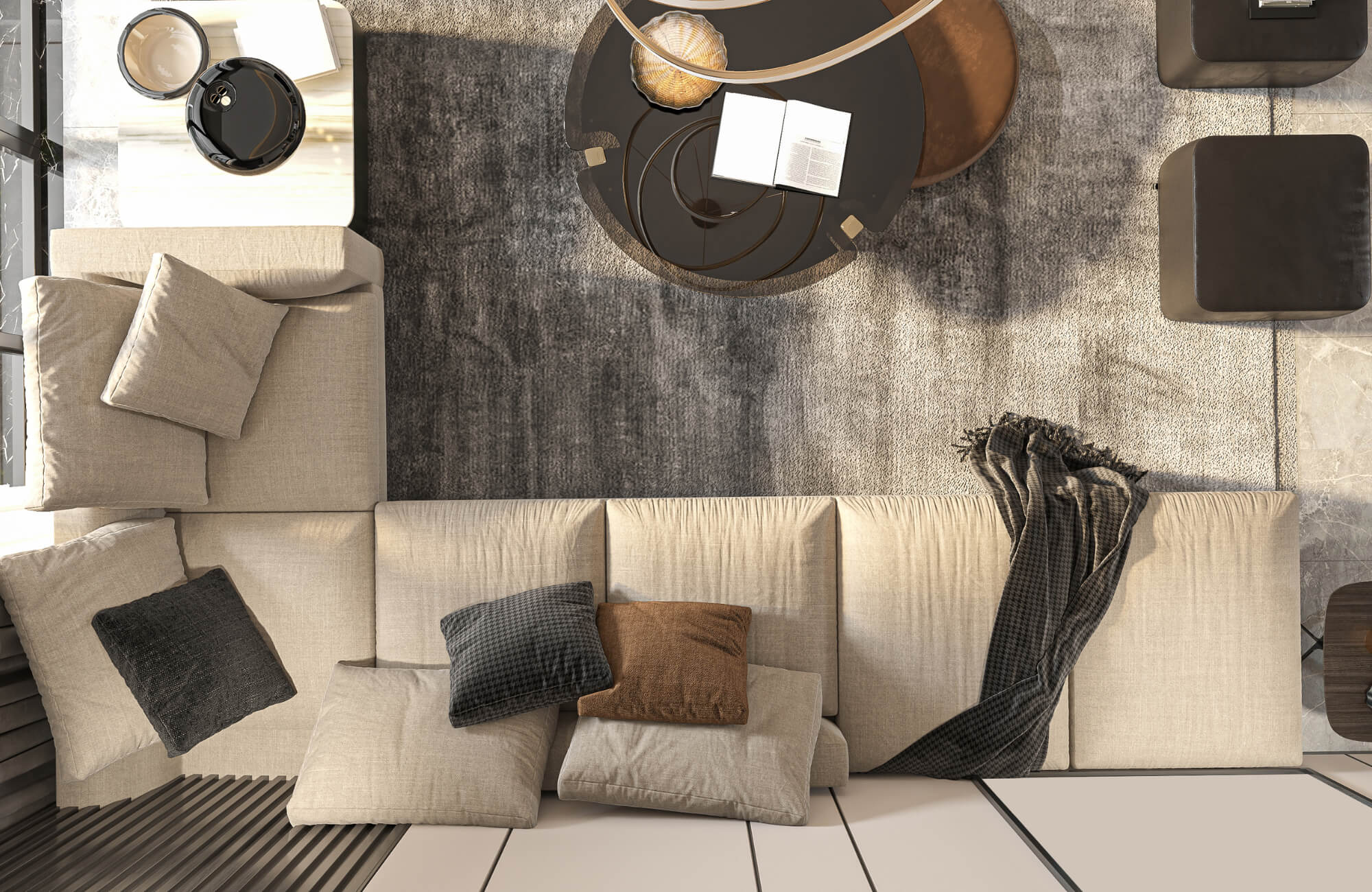 Top view of a modern living room with a neutral sofa styled with solid and patterned down pillows, layered over a textured area rug.