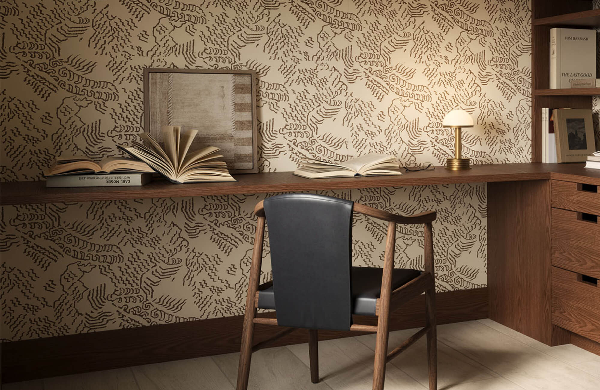 Contemporary home office with a wood desk and chair, patterned wall art, open shelving, books, and a desk lamp.