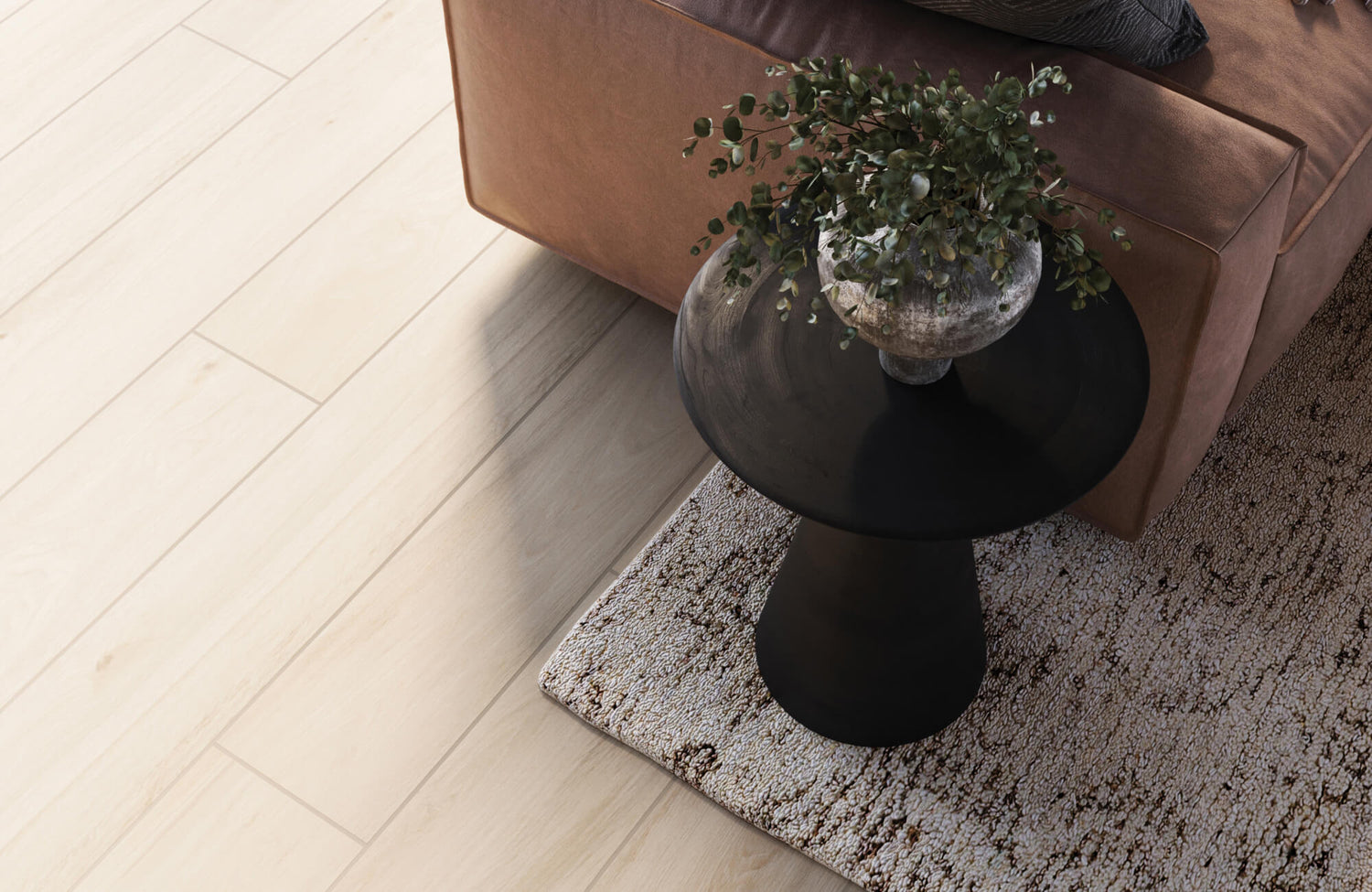 Modern living space featuring beige wood-look floor tiles complemented by a brown leather sofa, black pedestal side table, and neutral patterned rug.