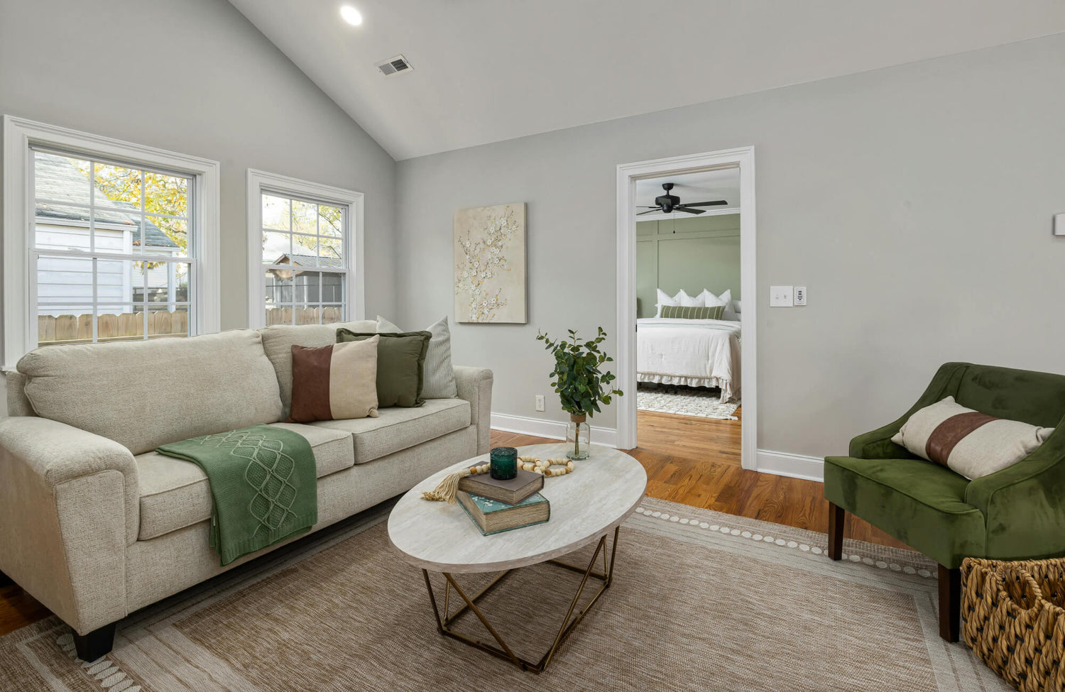 Sofa styled with four decorative pillows in mixed neutrals, evenly spaced for a balanced, everyday look.