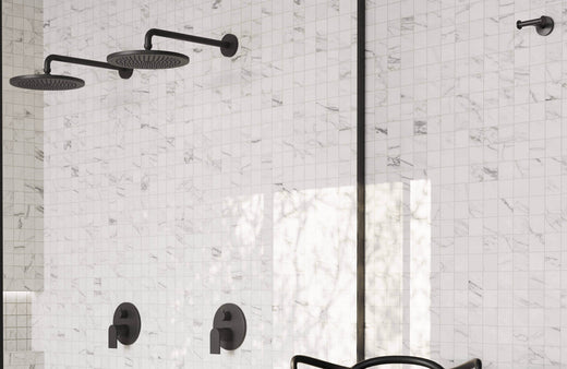 Elegant marble-look shower tiles in soft white with delicate gray veining create a bright and timeless aesthetic, complemented by sleek black matte fixtures for a modern touch.