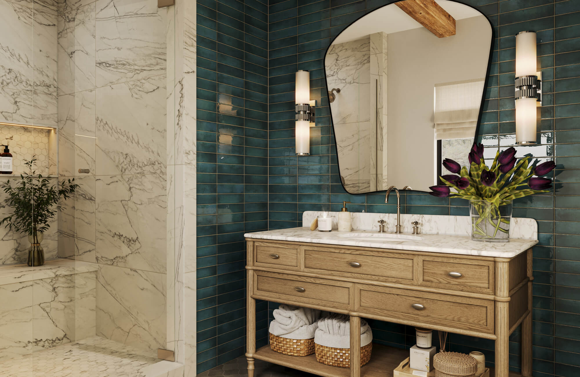 Arched bathroom mirror above a wood vanity with marble countertop, teal tile walls, and wall sconces creating balanced vertical spacing.