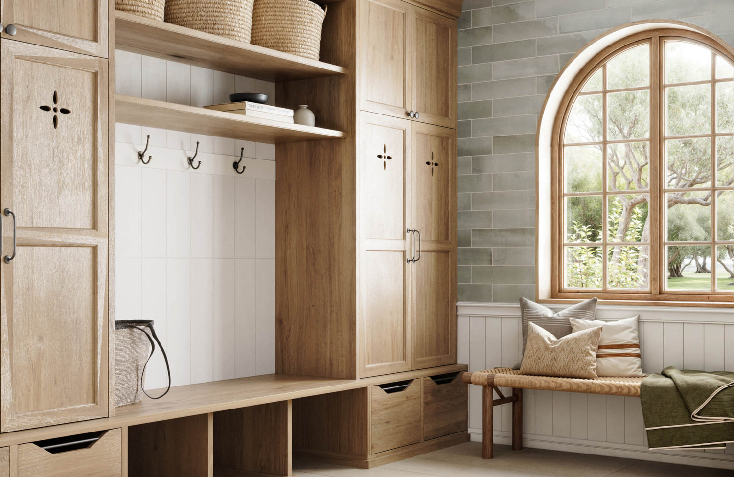 Rustic mudroom with natural wood cabinetry and open shelving, complemented by green subway tiles and an arched window framing a serene outdoor view.