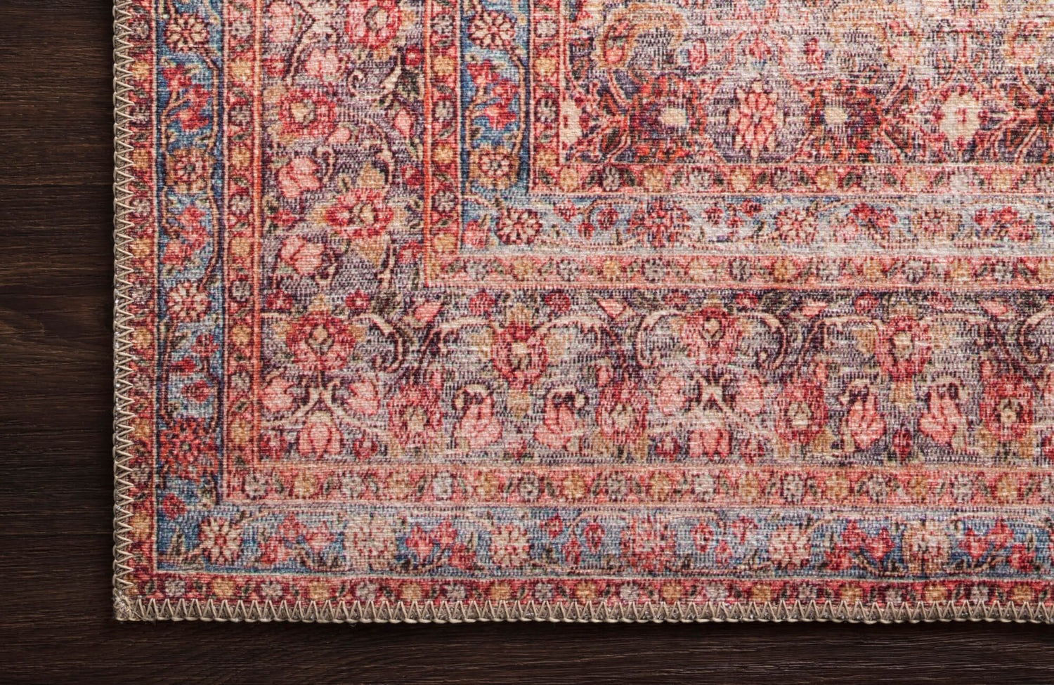 Pascal Polyester Face Rug in Scarlett/Navy, featuring an intricate floral pattern in rich red, blue, and beige tones for a vintage appeal.