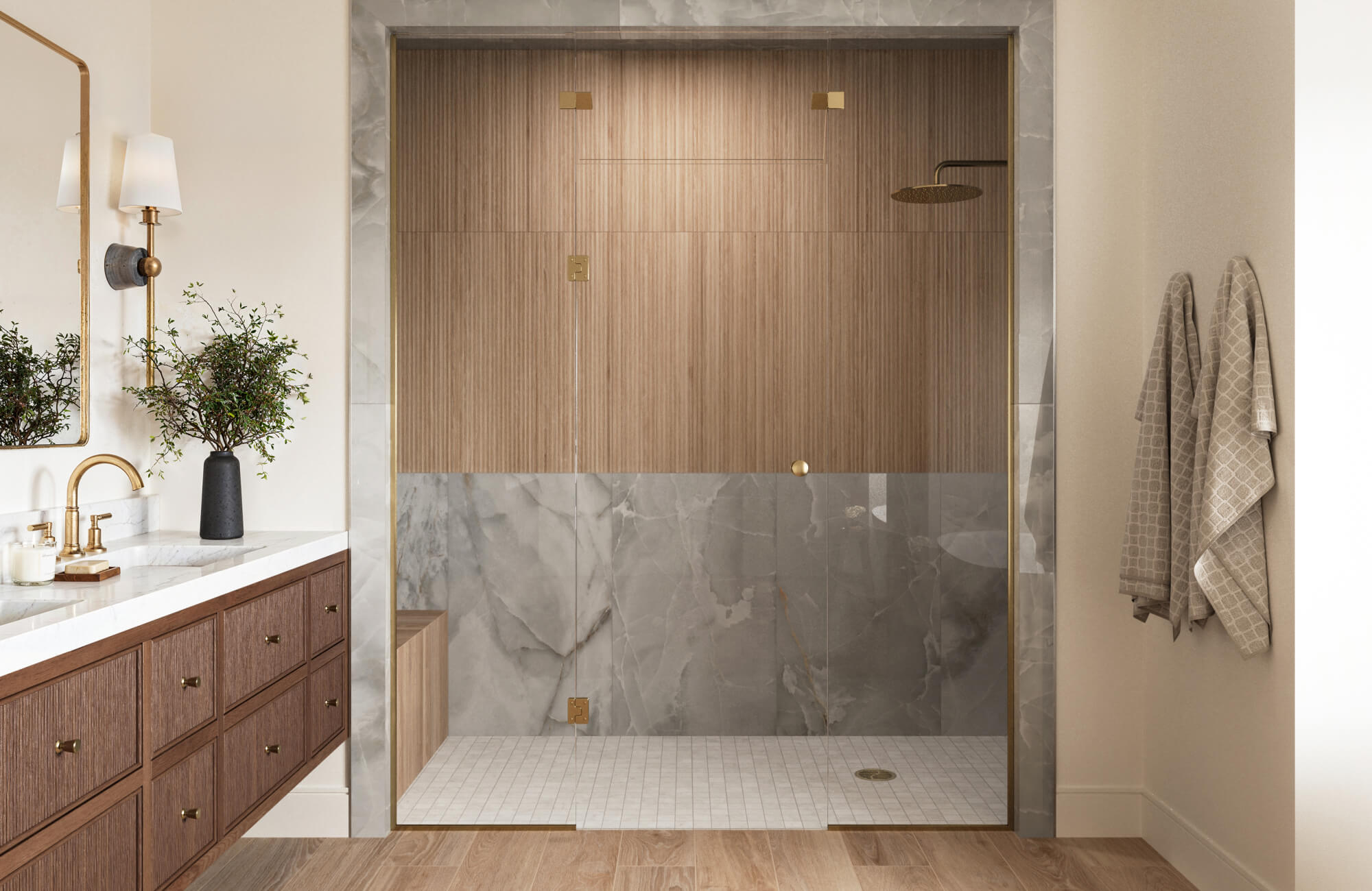 Modern walk-in shower with ribbed wood look tile wall, gray marble look panels, mosaic shower floor, wood-inspired bathroom flooring, vanity, sconce, glass enclosure, and brushed brass fixtures.