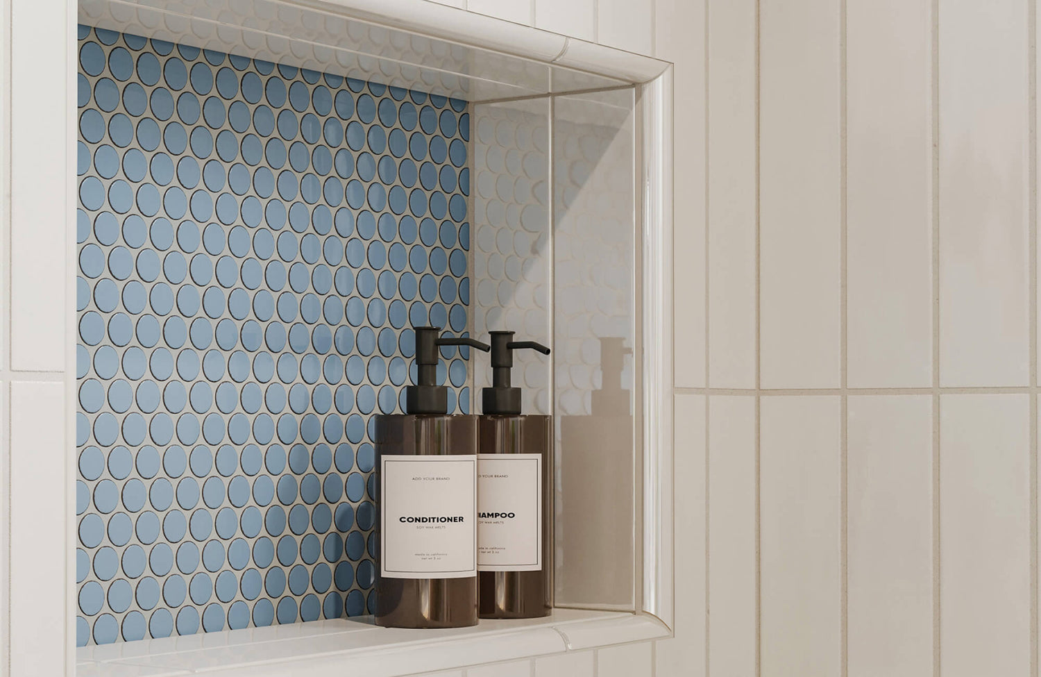 Shower niche with blue oval mosaic tile and two labeled pump bottles for shampoo and conditioner, surrounded by glossy vertical white tiles.