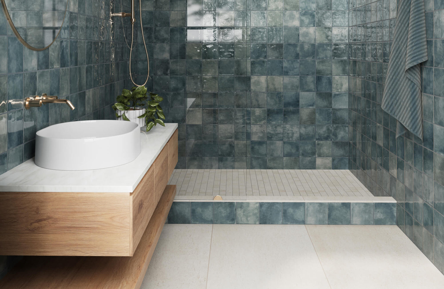 Modern bathroom with glossy teal square tiles, a white vessel sink, and light wood vanity, creating a serene, spa-like ambiance.