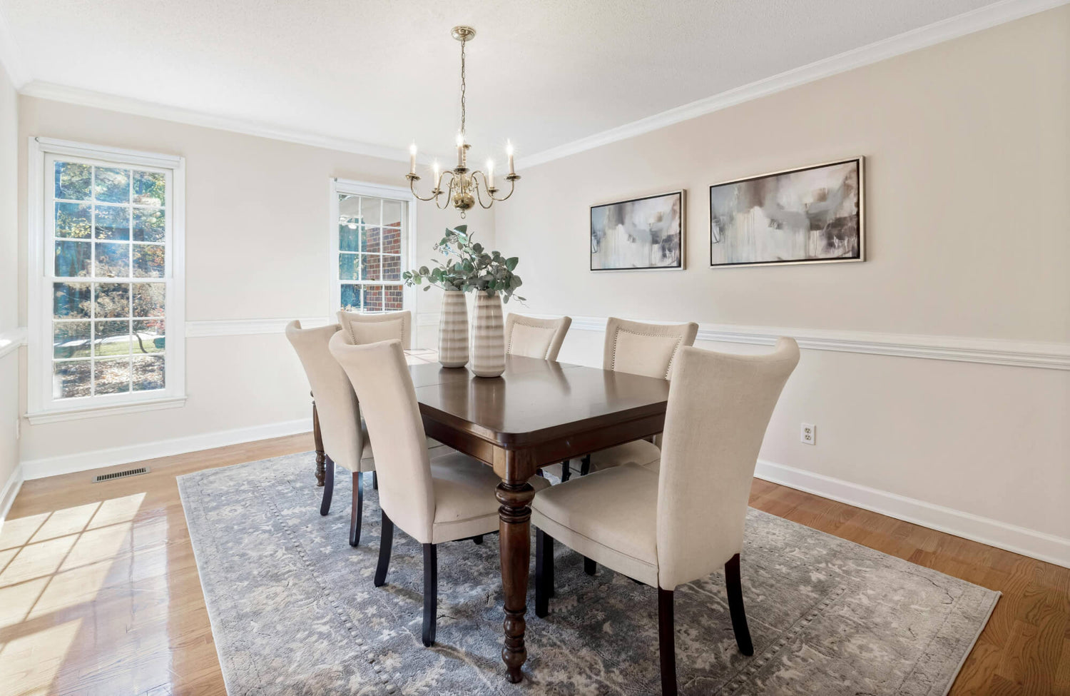 Rectangular rug placed under a dining table with all chairs fully supported for balanced, comfortable seating.
