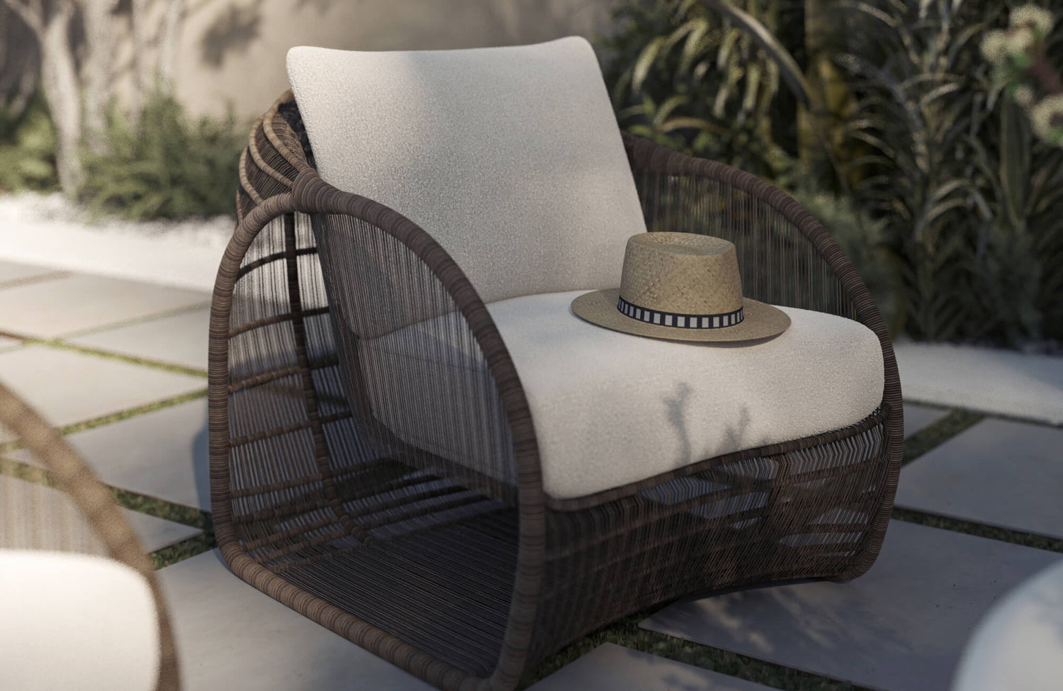 Outdoor lounge chair with woven detailing and plush white cushions, reflecting the comfort and layered styling that help shape a great outdoor lounge space.