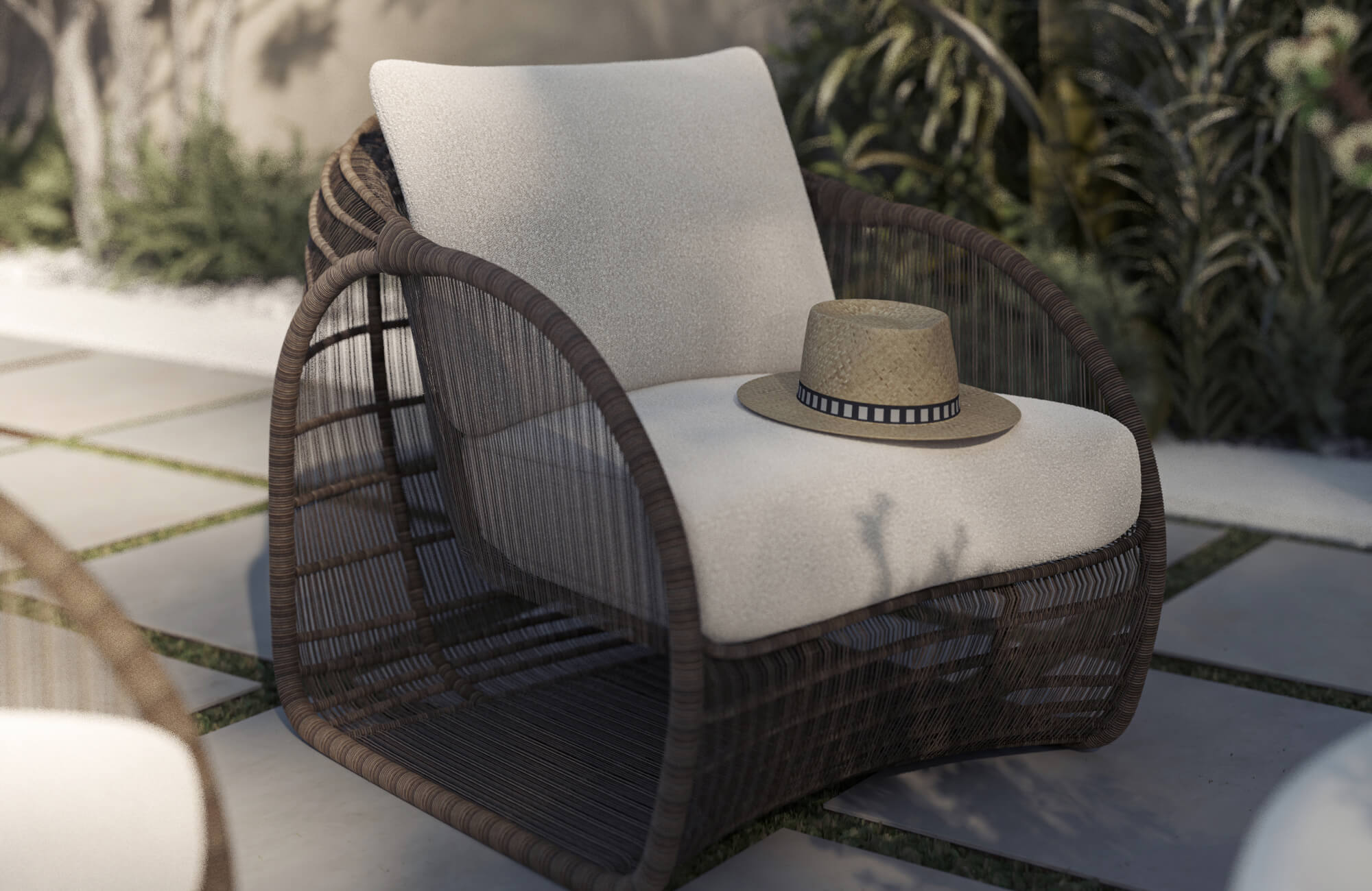 Outdoor lounge chair with woven detailing and plush white cushions, reflecting the comfort and layered styling that help shape a great outdoor lounge space.