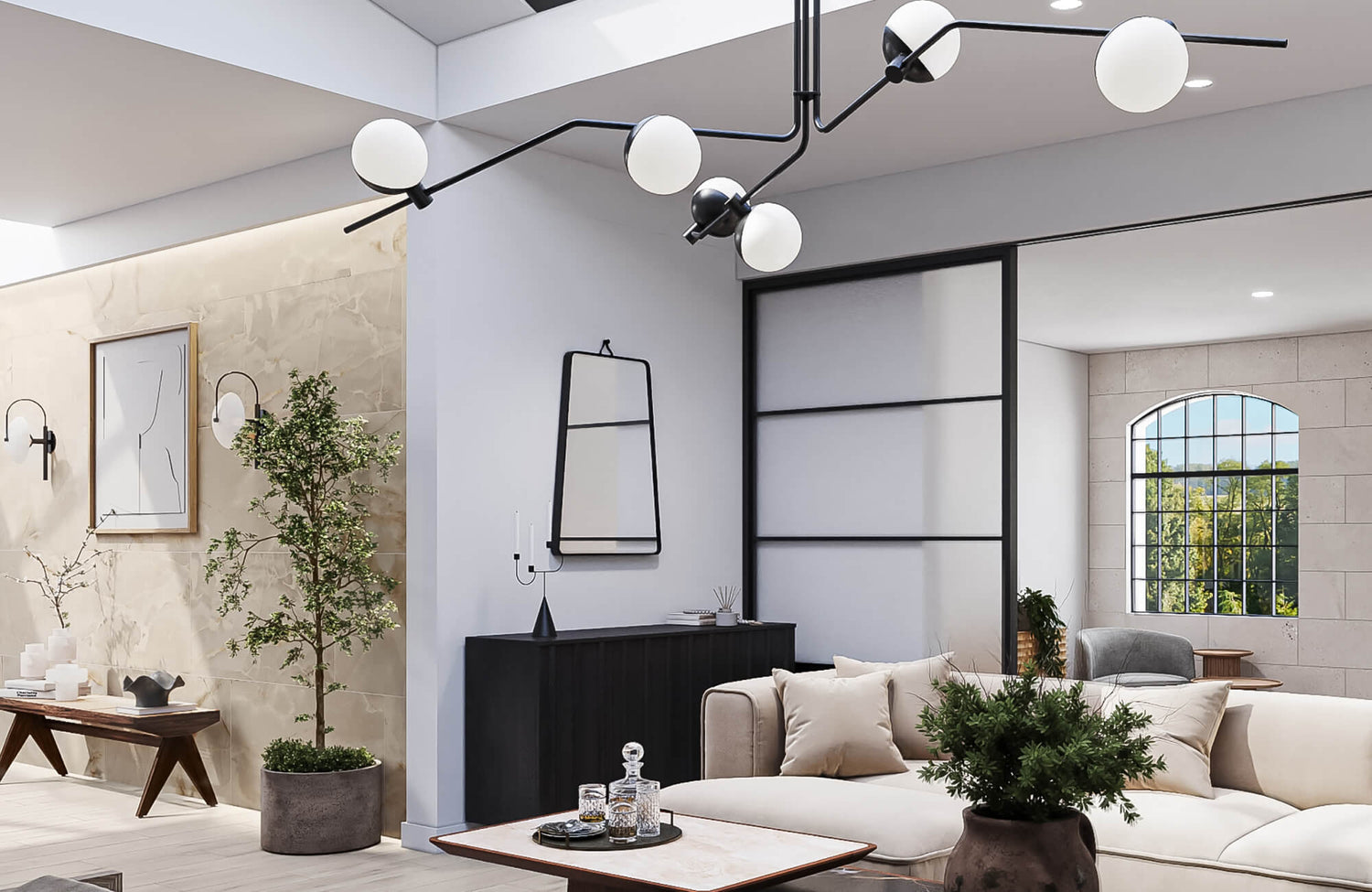 Contemporary chandelier with black metal arms and frosted globe bulbs suspended above a neutral-toned living room.