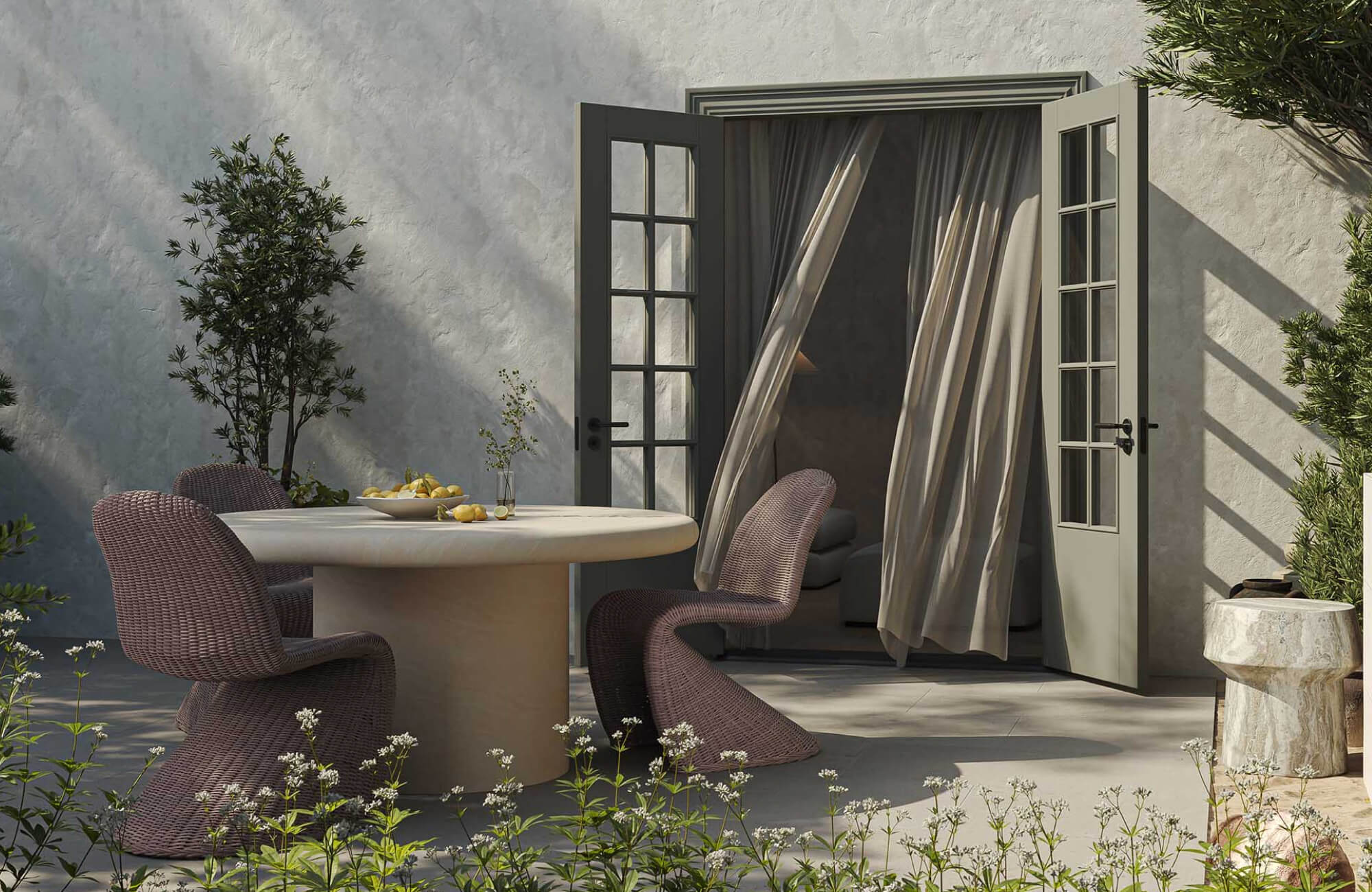 Outdoor patio with sculptural woven chairs, a round dining table, an end table, open French doors, and soft neutral finishes.
