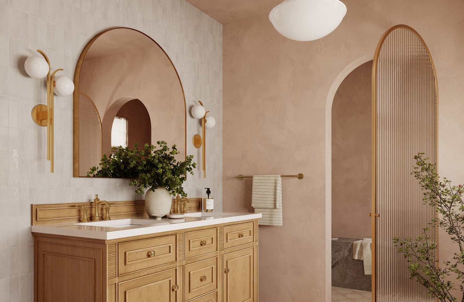 Bathroom vanity with arched mirror reflecting soft light, showing how scale and placement enhance balance in design.