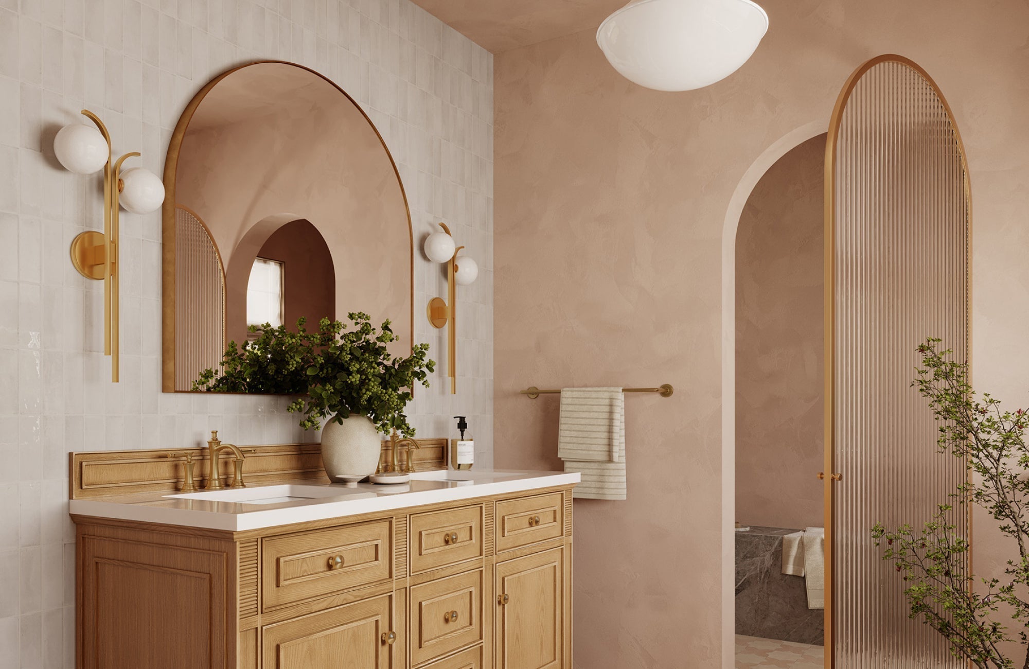 Bathroom vanity with arched mirror reflecting soft light, showing how scale and placement enhance balance in design.