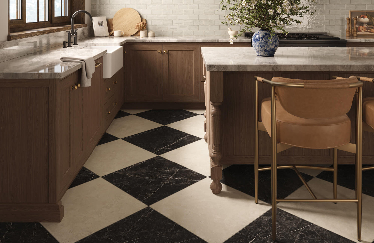 Warm kitchen with tan counter stools tucked under a marble island, highlighting stool height and legroom at the counter.