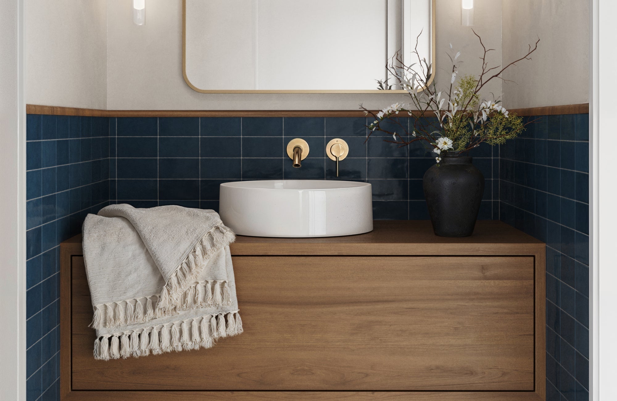 Modern powder room with deep blue backsplash, wood vanity, round vessel sink, and gold wall-mounted fixtures.