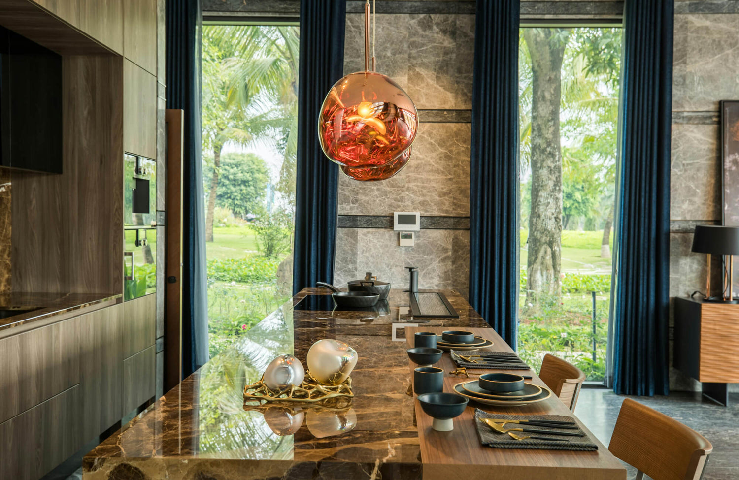 Modern rectangular dining table with marble top set for a family meal, framed by tall windows, rich textures, and warm contemporary lighting.