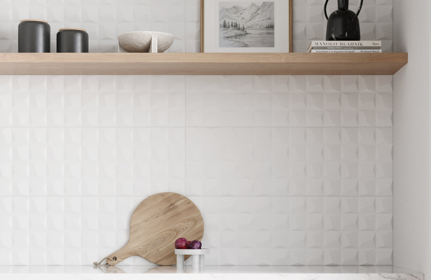 A white ceramic backsplash with 3D texture adds modern depth behind floating shelves and framed wall art in the kitchen space.