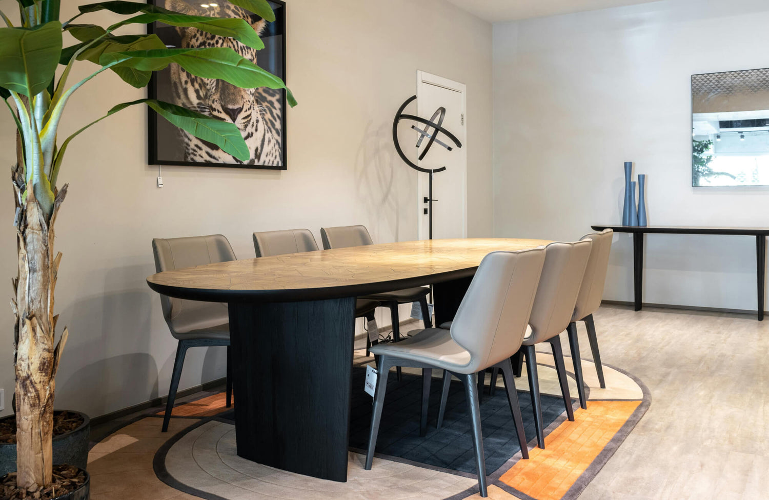 Oval dining table with rounded edges creating smooth circulation and balanced seating in a modern interior