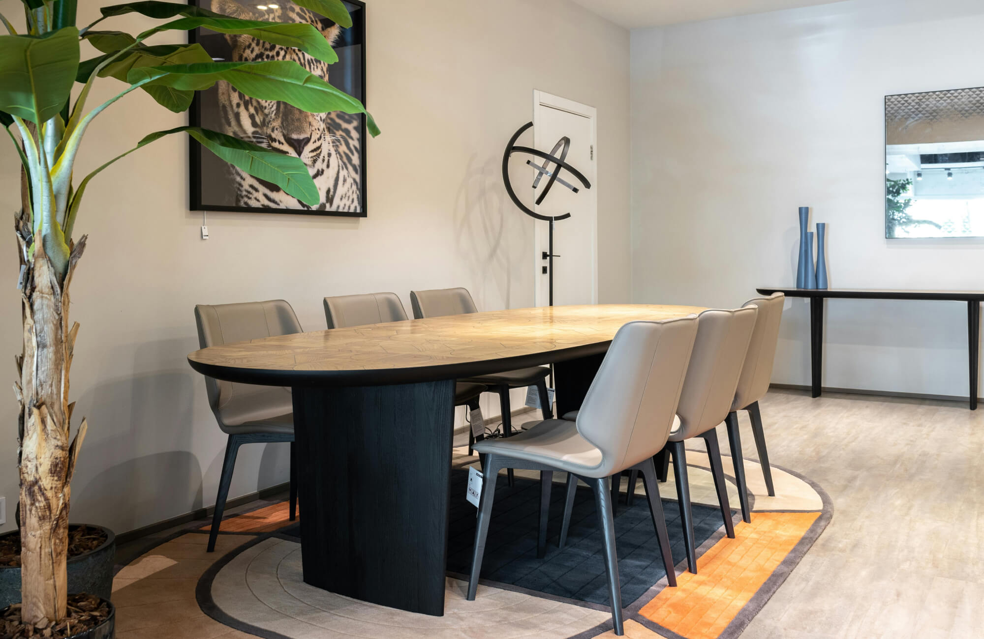 Oval dining table with rounded edges creating smooth circulation and balanced seating in a modern interior