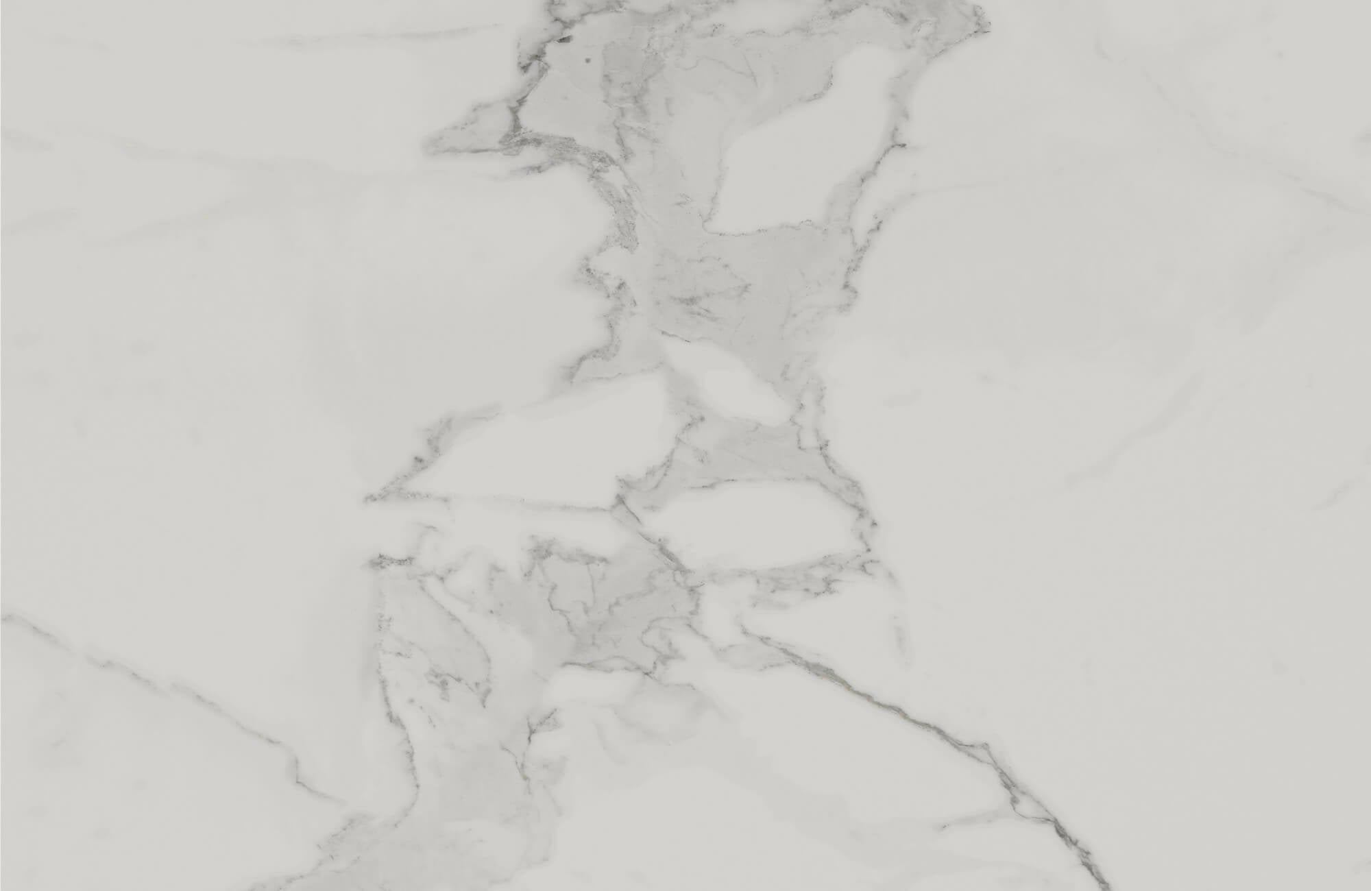 A close-up view of white calacatta marble showcasing soft gray veining flowing organically across a smooth, polished surface for an elegant, luxurious aesthetic.